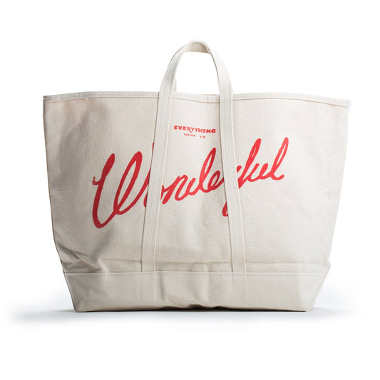 A large beige canvas tote bag with the word Wonderful printed in red cursive text on the front. The bag has two short handles for carrying.