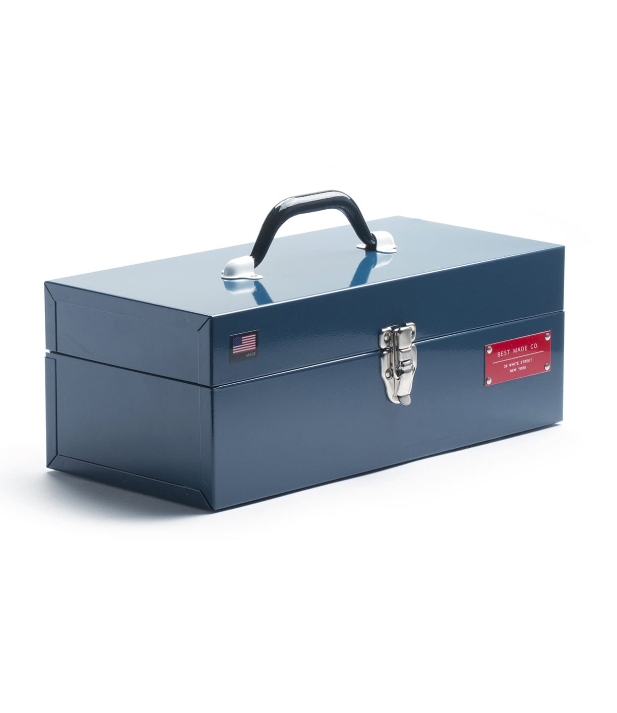 A blue metal toolbox with a black handle and a latch on the front. An American flag sticker and a red label reading Best Made Co. are affixed to the side.