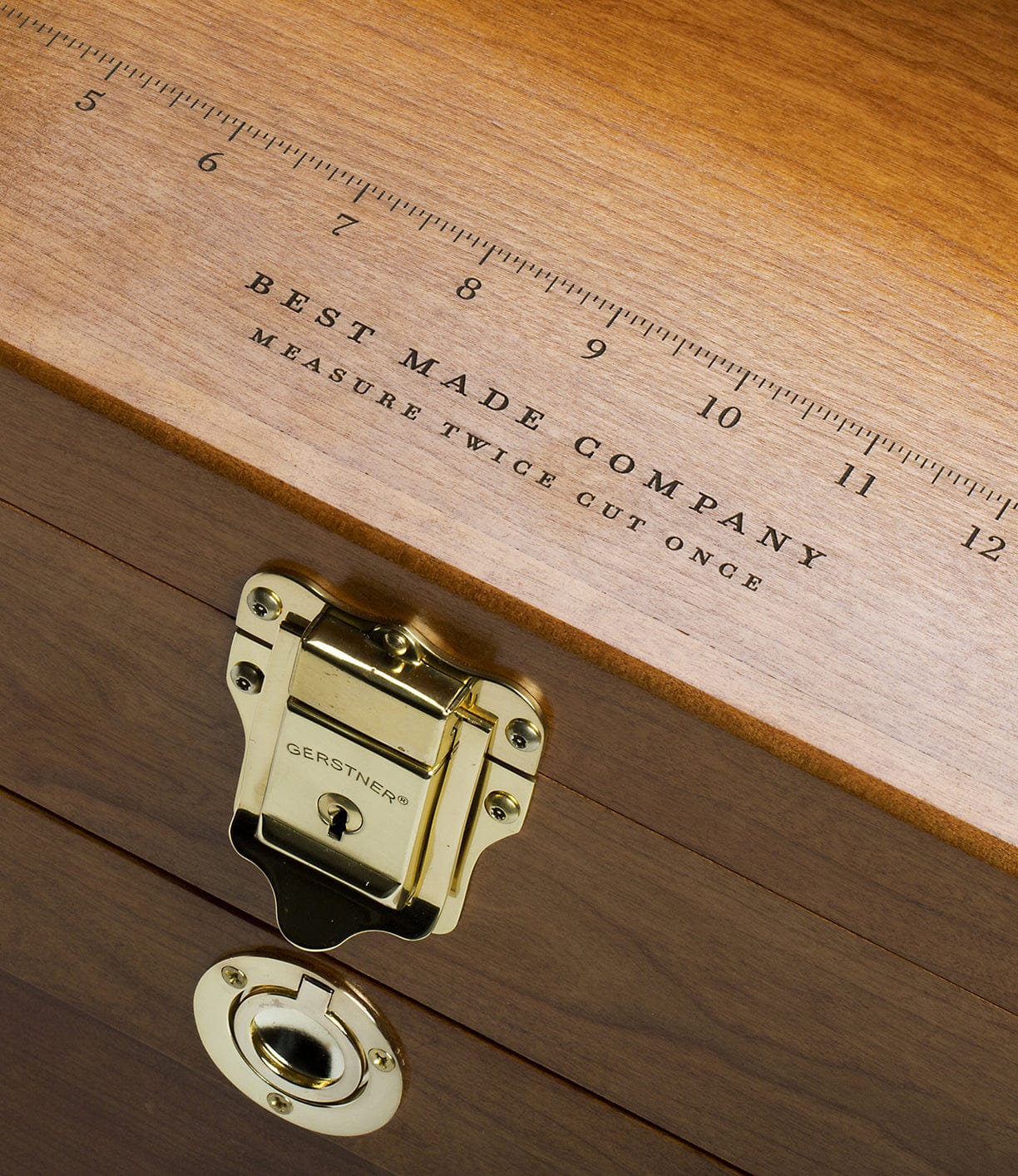 Wooden box with brass hardware and an engraved ruler on top labeled Best Made Company, Measure Twice, Cut Once.