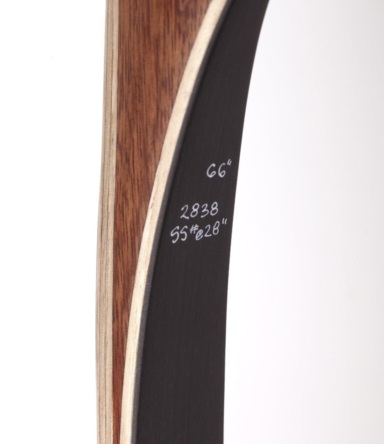 Close-up of a wooden bow with black inner surface. Measurements written on the black section include 66, 2838, and 55#@28.