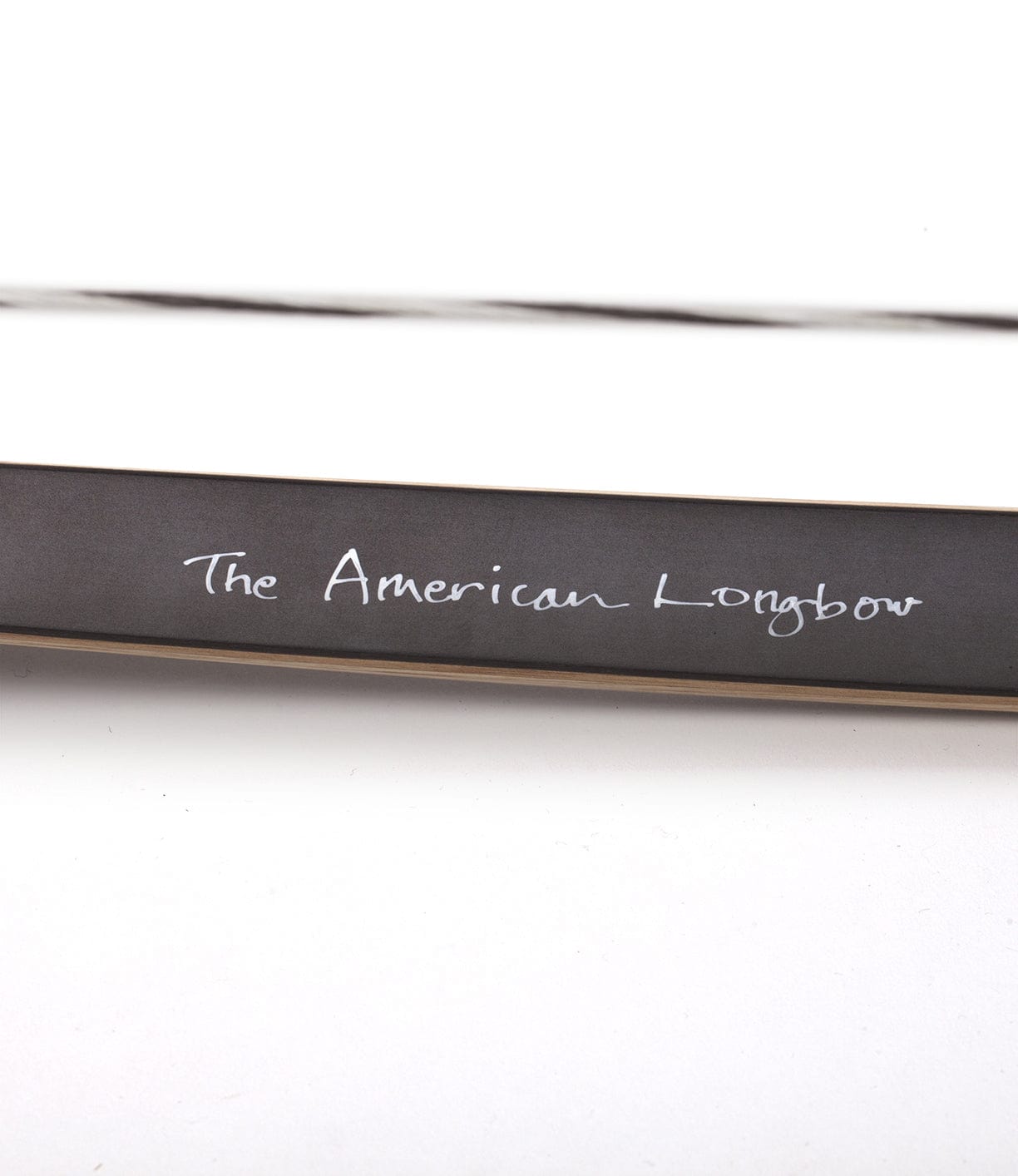 A close-up of a longbow with text The American Longbow written on it.