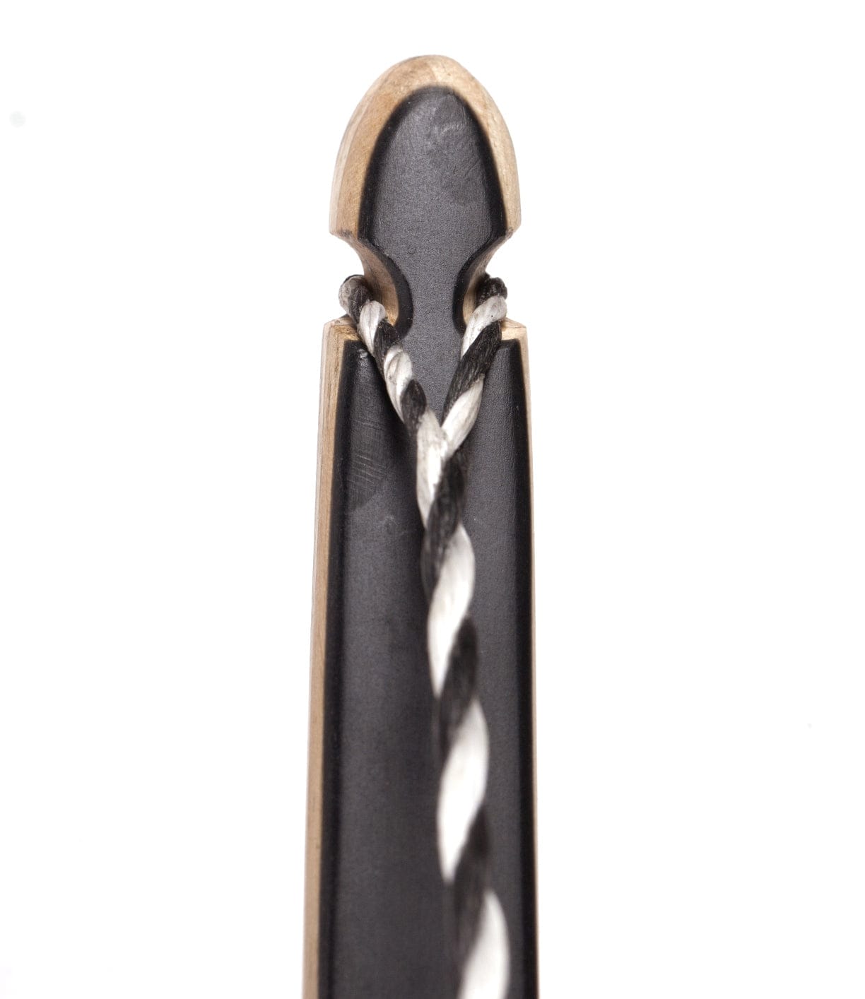 Close-up of the tip of a black bow with a white and black twisted bowstring looped around it. The bow has a notched design to hold the string in place.