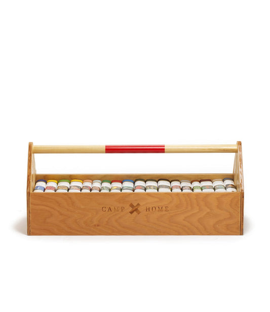 A wooden toolbox with a handle contains 24 small paint cans, organized in two rows. The toolbox is marked with the text Camp Home.