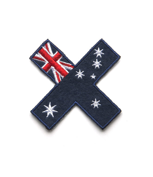 Fabric patch shaped like an X, featuring elements of the Australian flag and a white star constellation on a blue background.