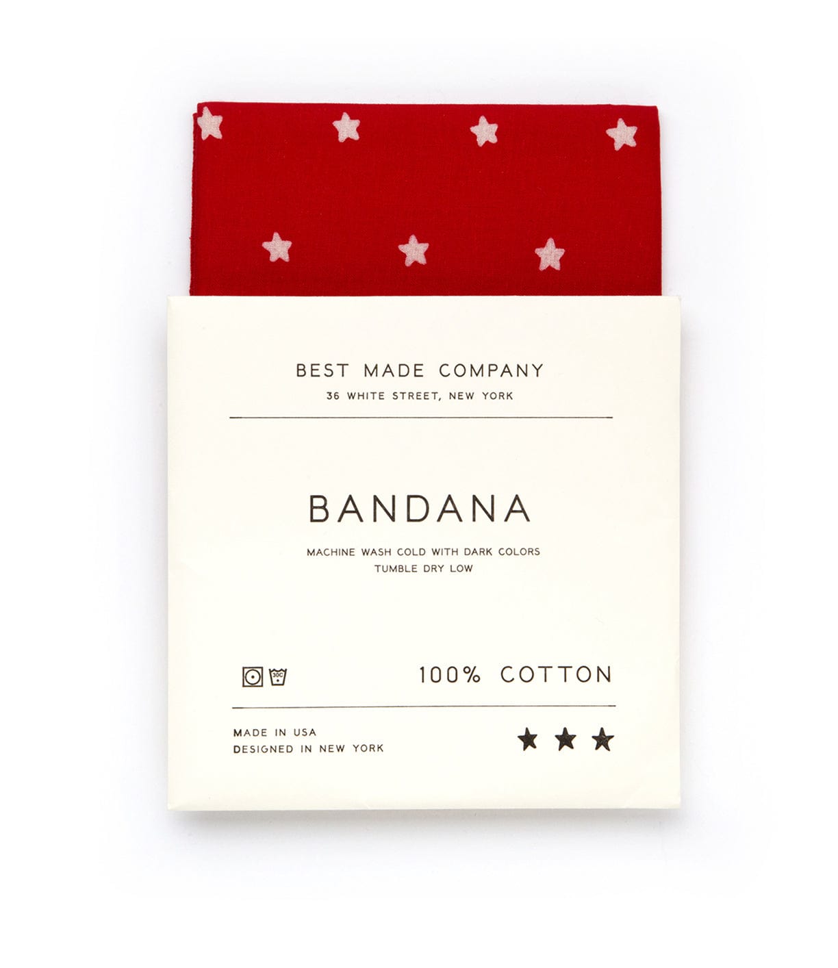 A red bandana with white stars, labeled Best Made Company Bandana, 100% cotton, in a white cardboard packaging. Instructions: machine wash cold with dark colors, tumble dry low. Made in the USA.