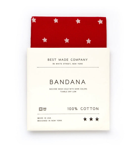 A red bandana with white stars, labeled Best Made Company Bandana, 100% cotton, in a white cardboard packaging. Instructions: machine wash cold with dark colors, tumble dry low. Made in the USA.