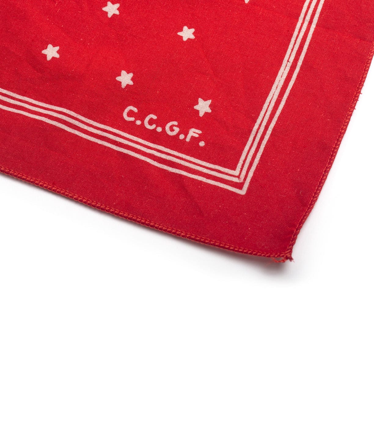 A red cloth with white stars and the letters C.C.G.F. printed near the corner.