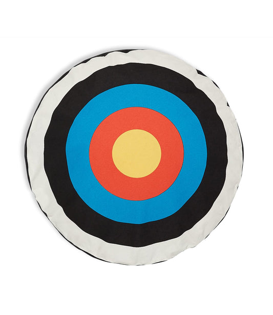 A circular archery target with concentric rings of black, white, blue, red, and yellow, viewed from above.