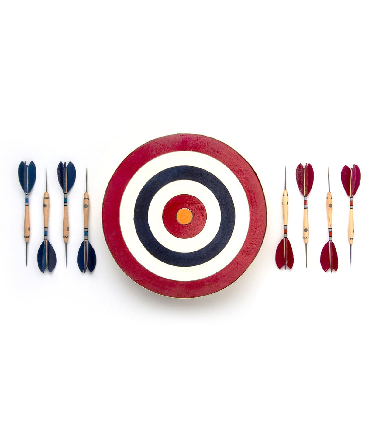 A circular darts target with red, white, and blue rings is centered, flanked by three blue feathered darts on the left and three red feathered darts on the right.