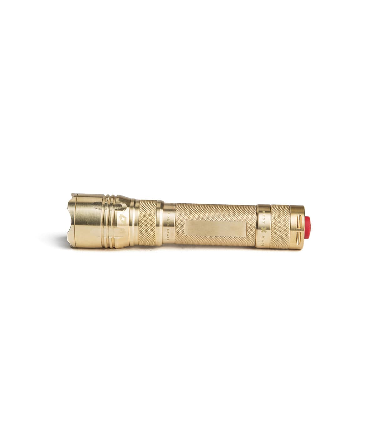 A brass-colored flashlight with a textured grip and a red button on one end.