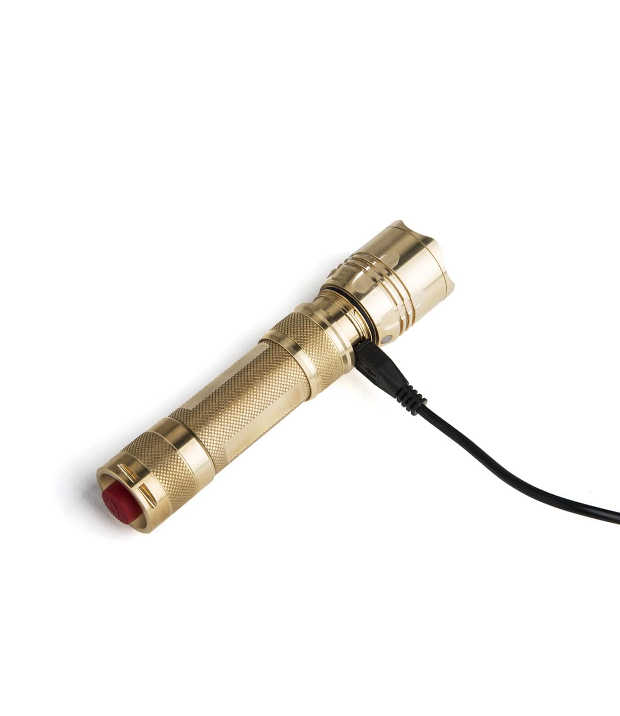 A gold-colored flashlight connected to a black charging cable.