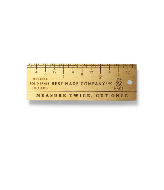 A brass ruler marked Best Made Company Inc. with a measuring scale from 0 to 6 inches and the phrase Measure Twice, Cut Once engraved below.