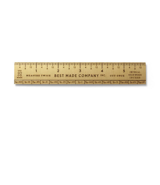 A 12-inch brass ruler engraved with Best Made Company Inc. and the phrase Measure Twice, Cut Once.  It includes both inch and millimeter markings.