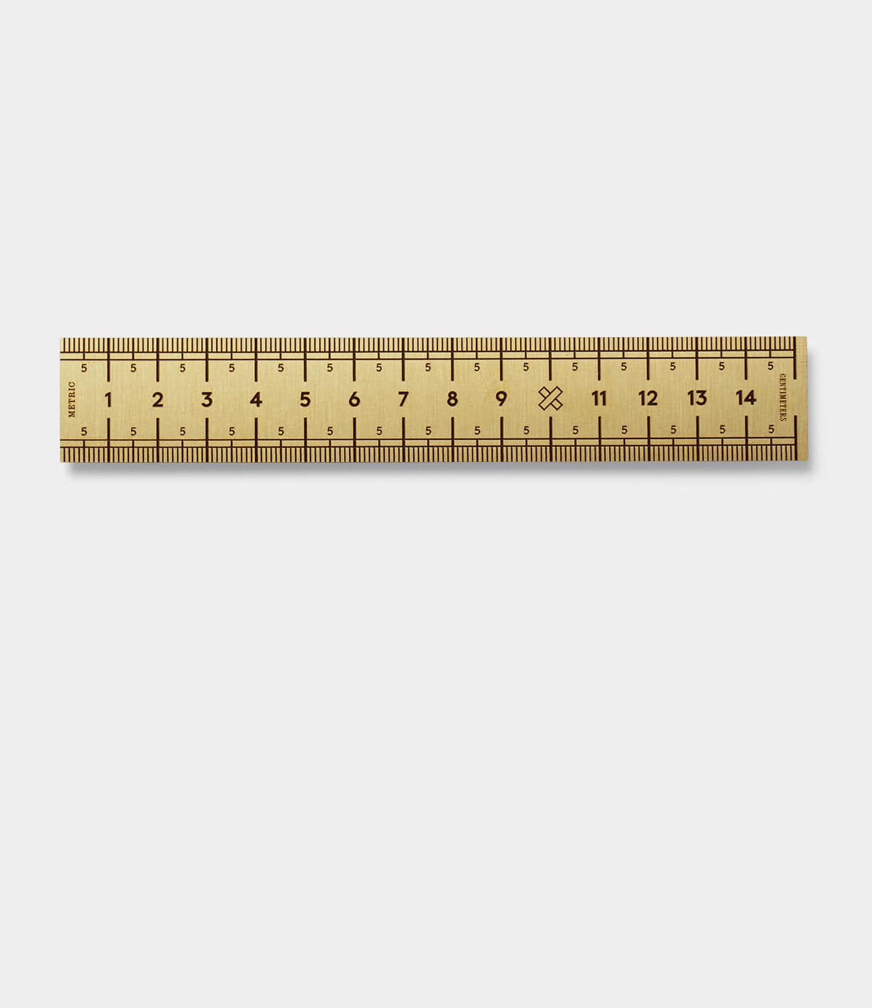 A wooden ruler with both centimeter and inch markings, measuring up to 15 centimeters and 6 inches, placed on a plain white background.