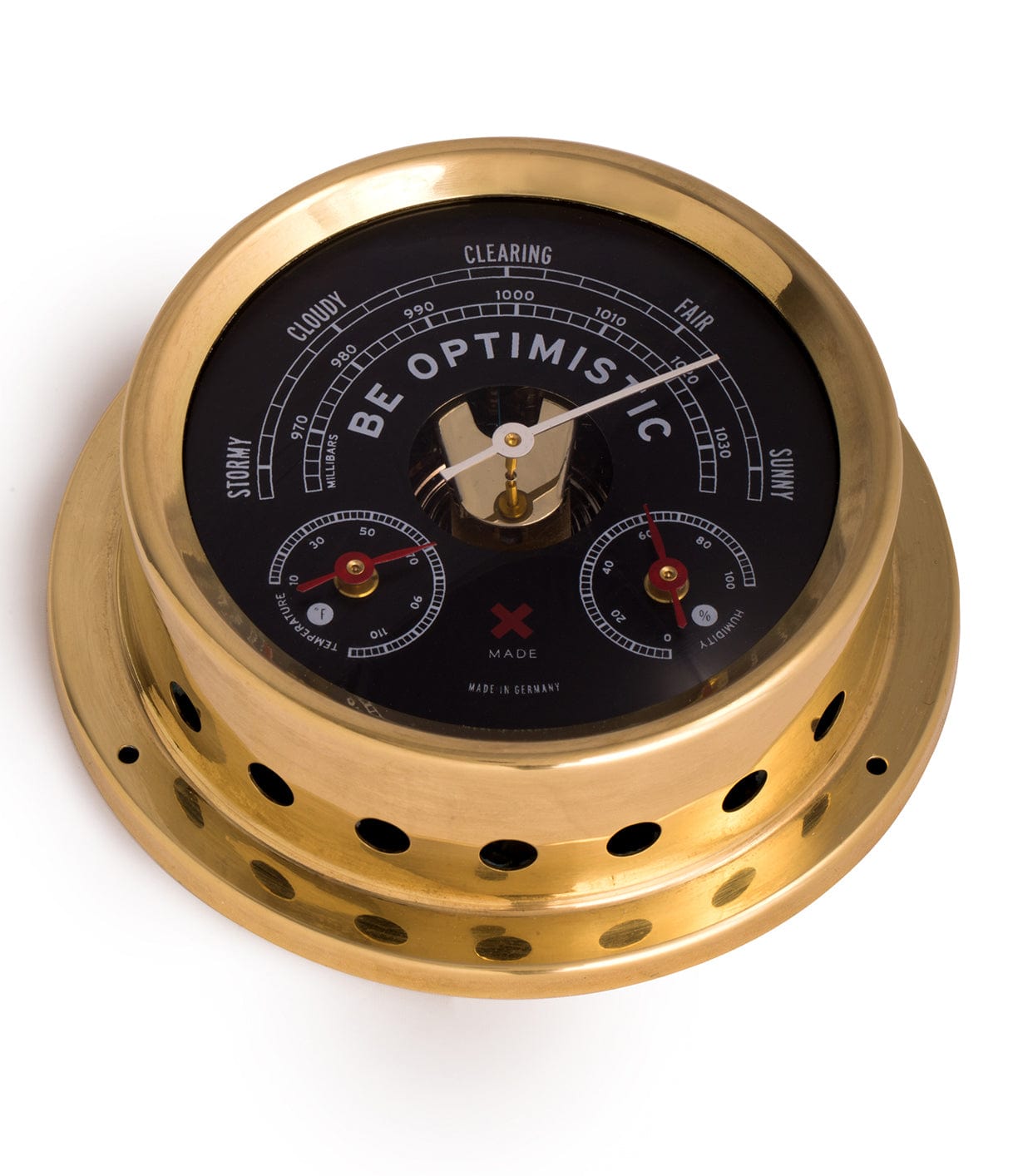 A brass barometer with Be Optimistic displayed on the front, indicating weather conditions from stormy to sunny. The device features additional gauges and multiple holes around its base.