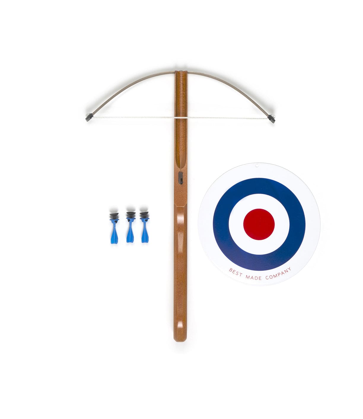 A classic wooden crossbow is displayed alongside three blue-tipped darts and a circular target with concentric red, white, and blue rings labeled Best Made Company.