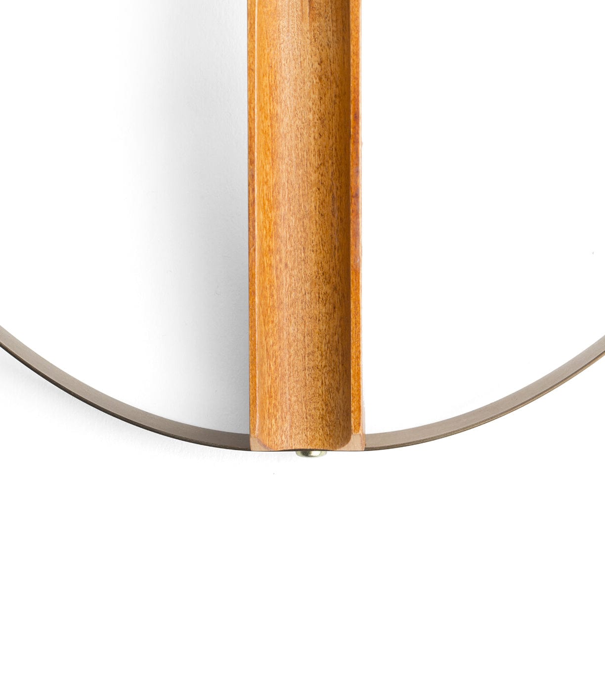 Close-up of a wooden bracket holding a thin, curved metallic strip against a white background.