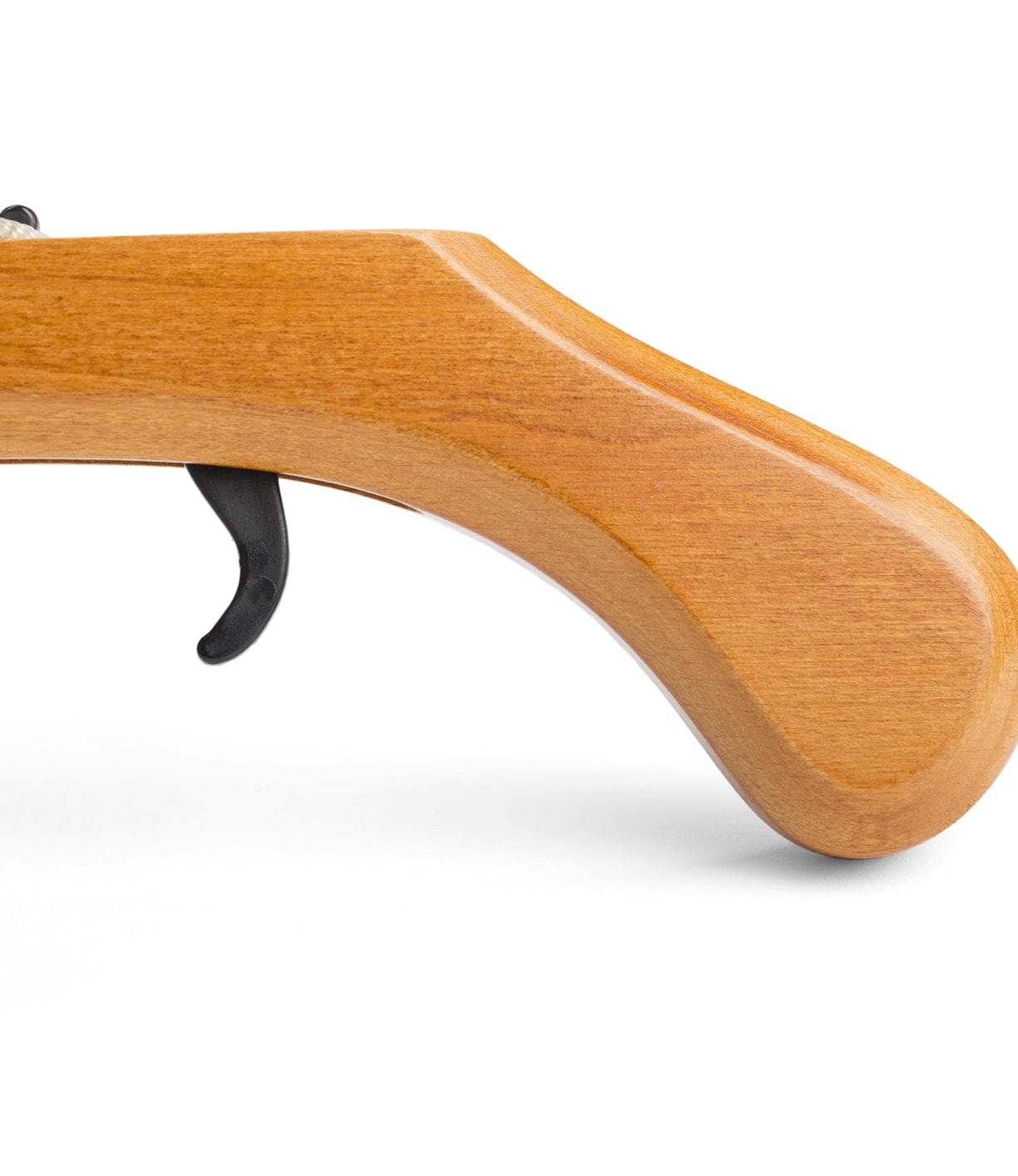 Close-up of the wooden handle and trigger of a rifle against a white background.