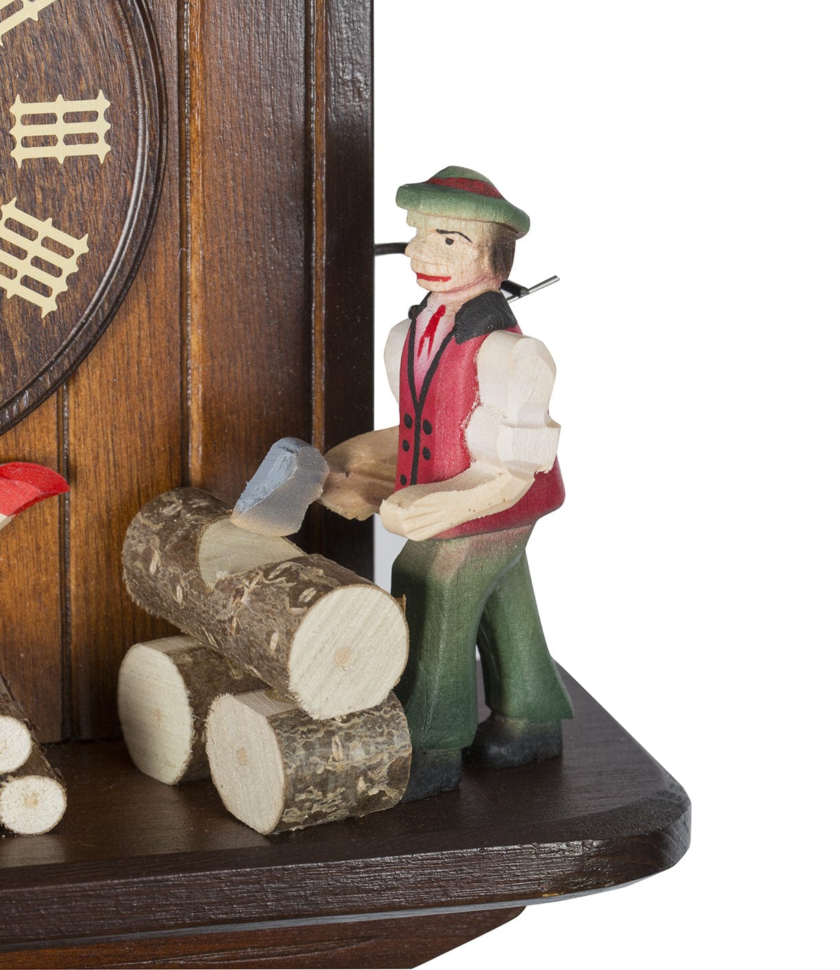 Wooden figurine of a man in traditional attire chopping wood, part of a cuckoo clock decor.