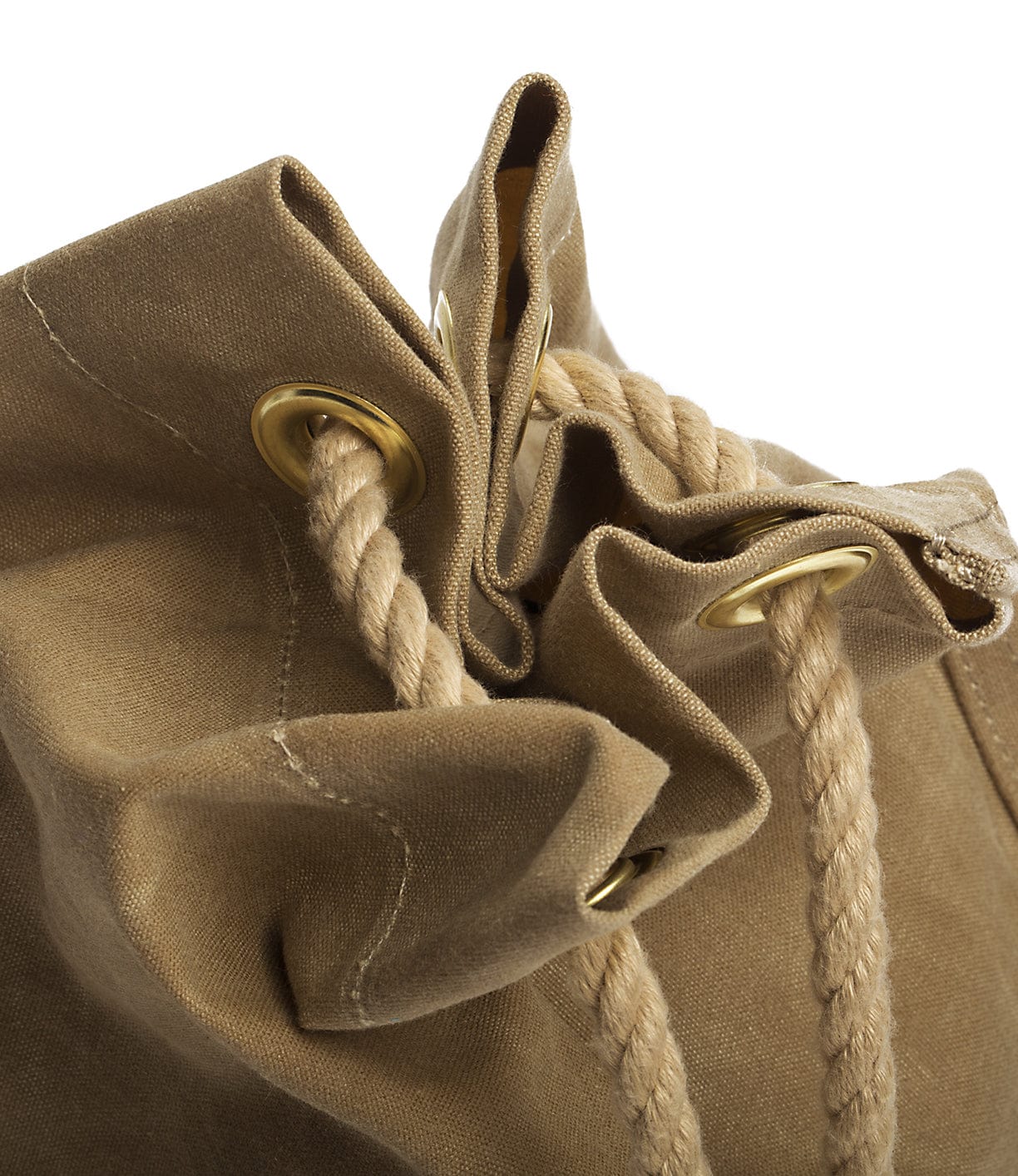 Close-up of a beige canvas bag with braided drawstrings threaded through metal grommets.