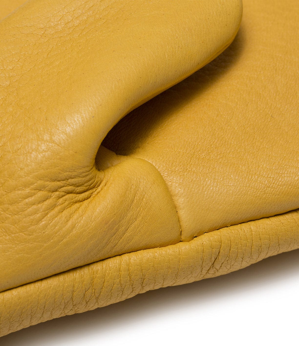 Close-up of a section of yellow leather, showing the texture and natural folds.