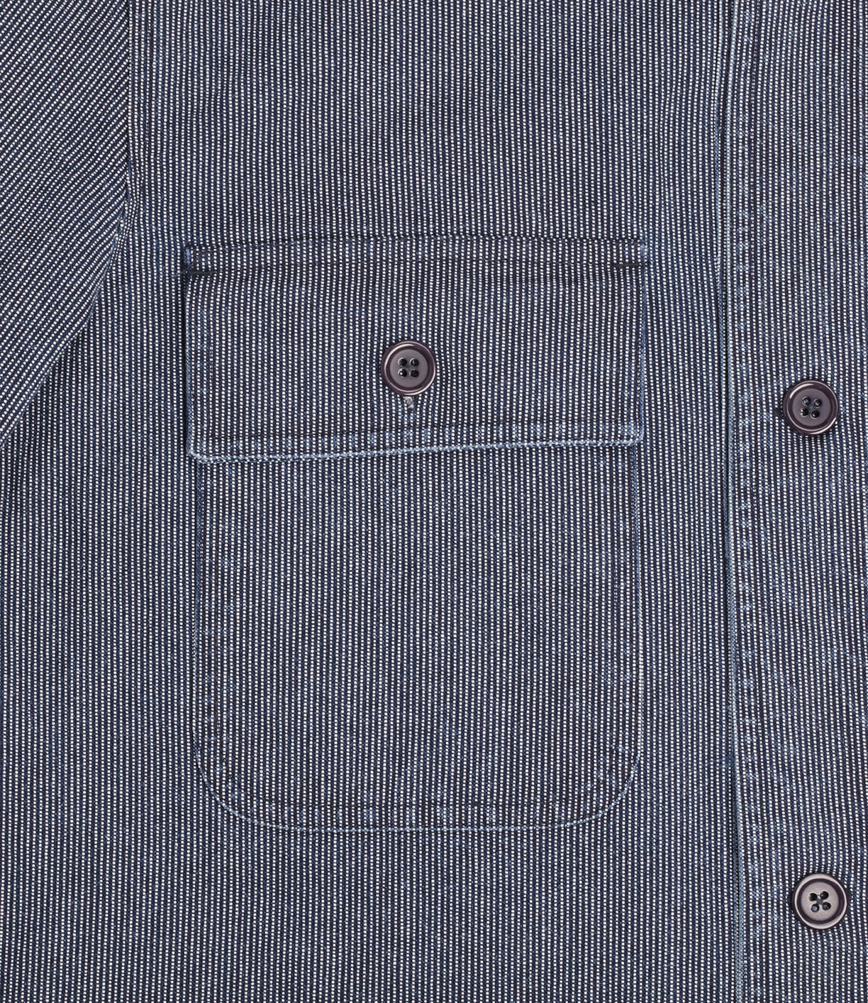 Close-up image of a gray fabric garment featuring a chest pocket with a button flap and two buttons to the right.