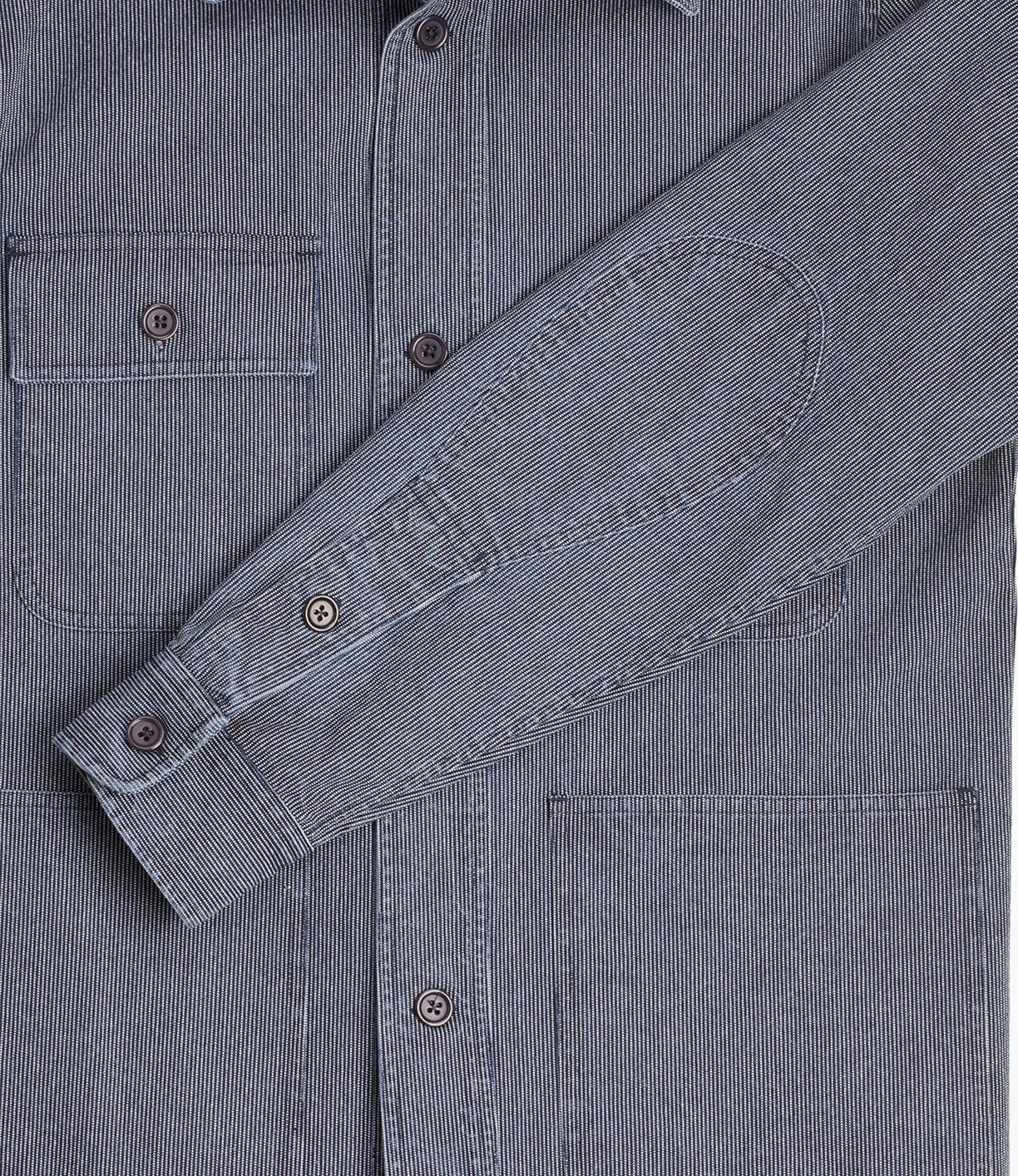 Close-up of a grey, long-sleeve shirt with a visible breast pocket. The shirt features a textured pattern and several buttons down the front and on the sleeve.