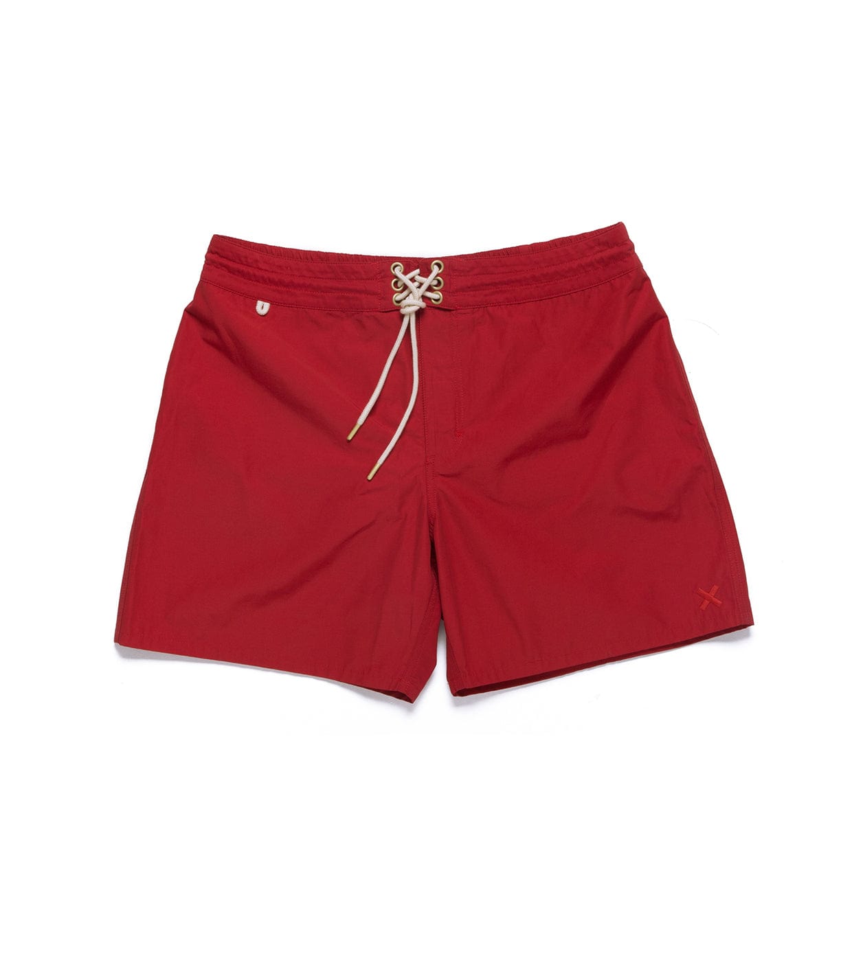 Red swim shorts with white drawstring closure, an embroidered shield logo on the left, and an X design on the right leg.