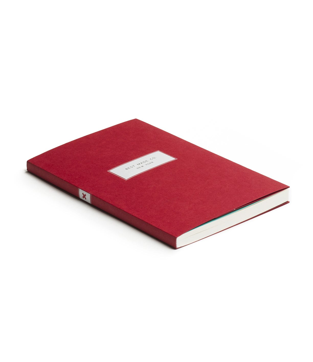 A closed, red hardcover book lies flat on a white surface with a small, centered label on its front cover.