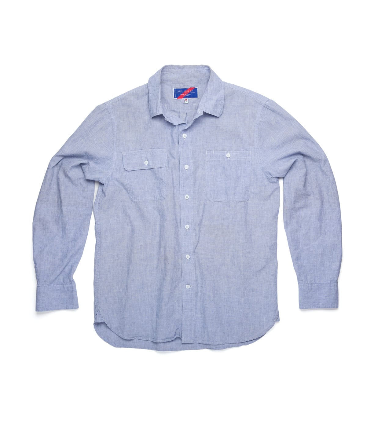 Light blue long-sleeve button-up shirt with two front pockets, displayed on a white background.