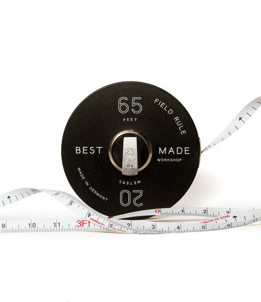 A black tape measure labeled 65 Feet and 20 Meters with Best Made Workshop branding. It has a white tape with markings in both feet and meters.