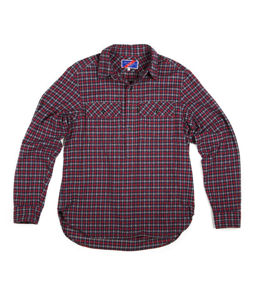 A long-sleeved, plaid shirt with red, green, and blue checks, featuring two buttoned chest pockets.