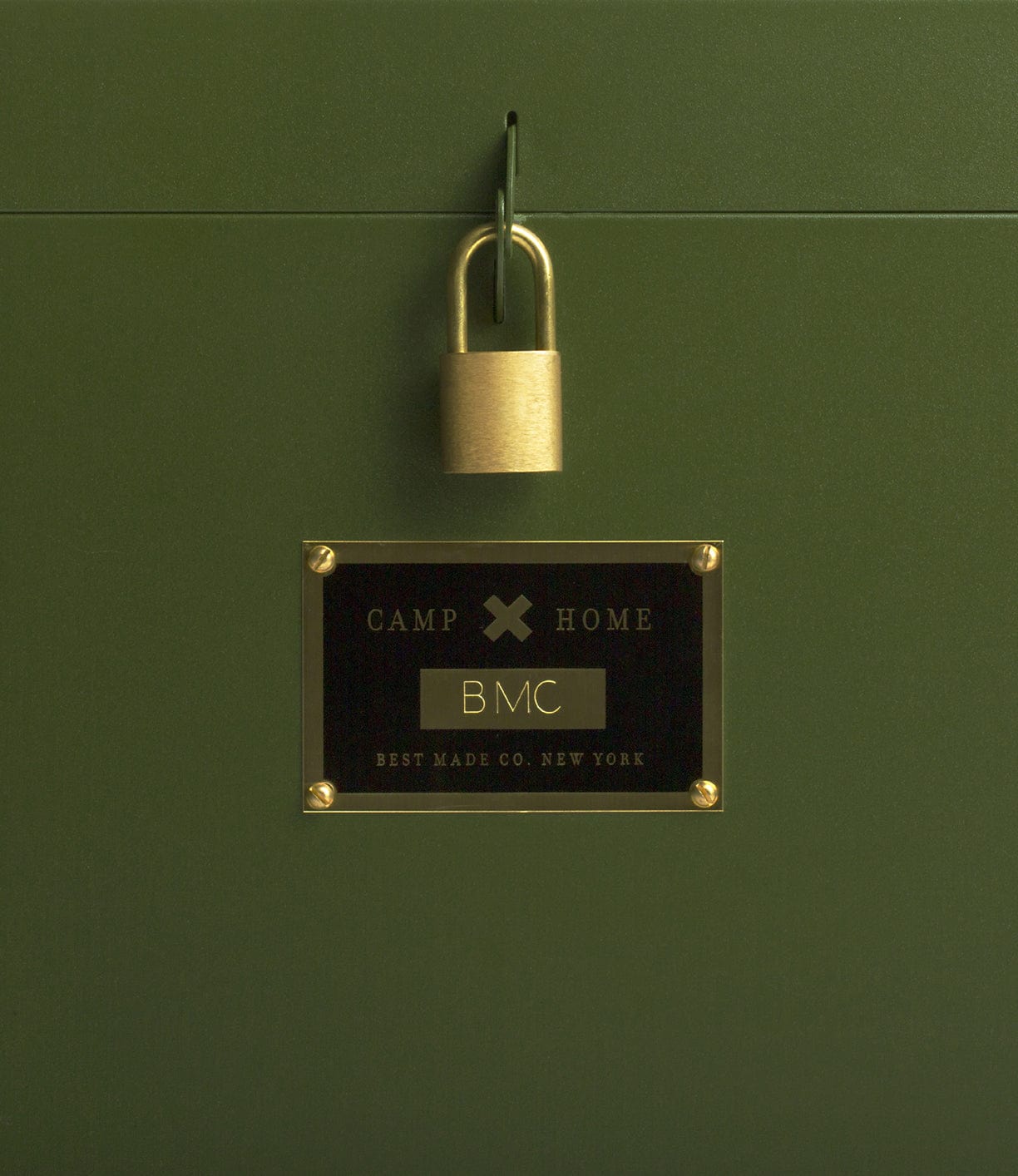 A green metal box with a brass padlock. A label reads: Camp Home, BMC, Best Made Co. New York.