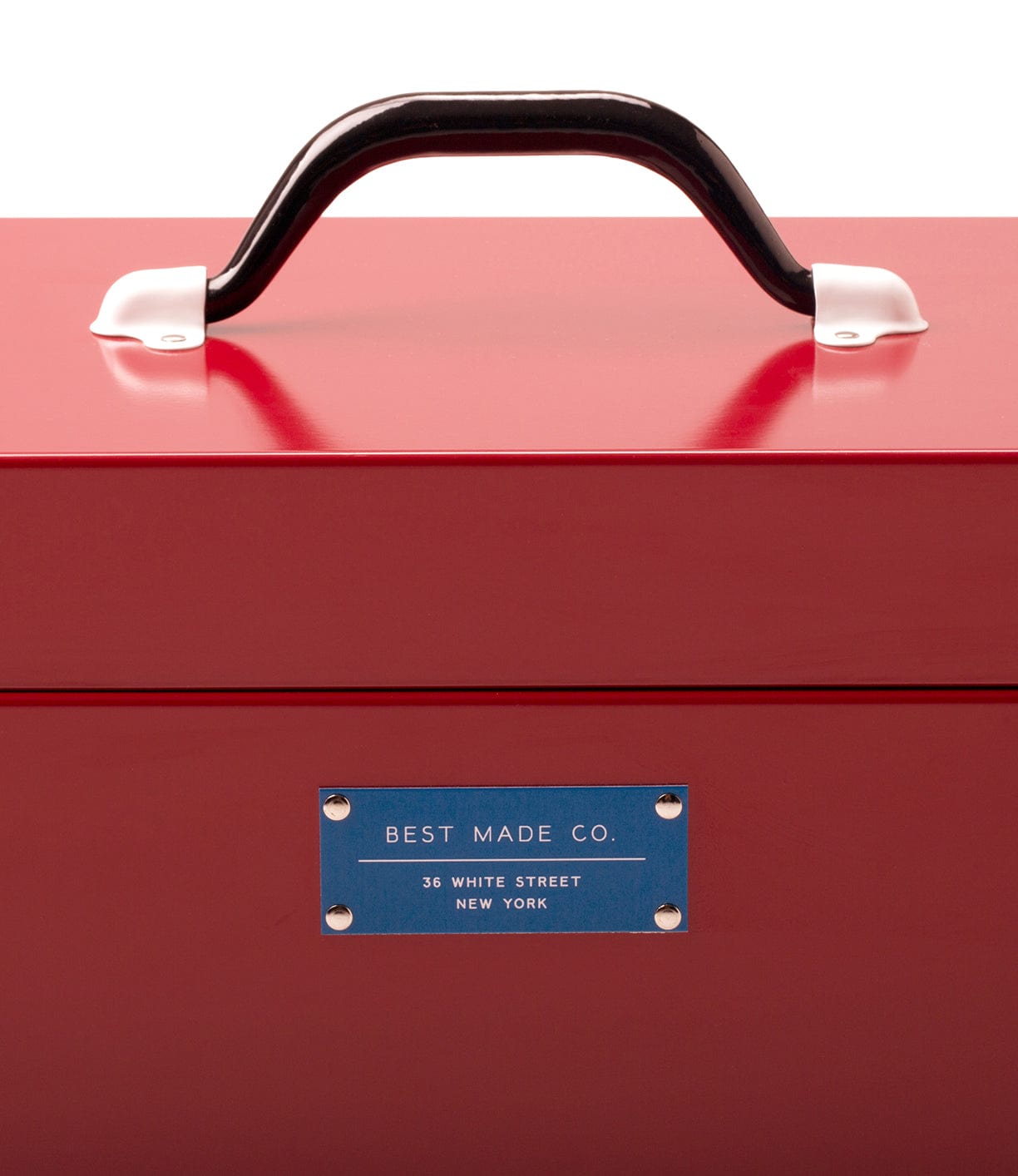 A red metal box with a black handle and a blue label that reads Best Made Co., 36 White Street, New York.