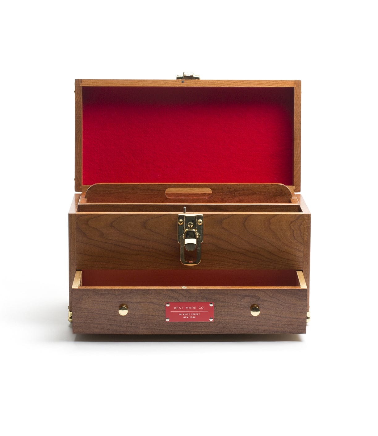 A wooden chest with a red interior is open, revealing a single compartment and a small drawer below. A brass latch is centered on the front.