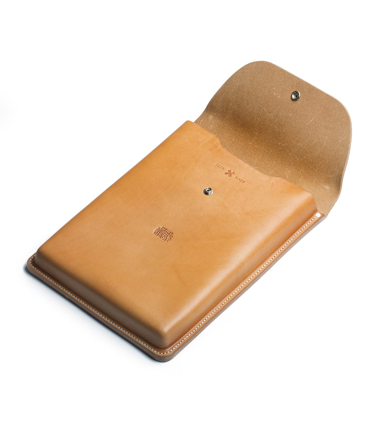 A tan leather sleeve with a snap-button closure, open to reveal its interior. The leather is smooth, with stitched edges and minimalist branding visible on the front.