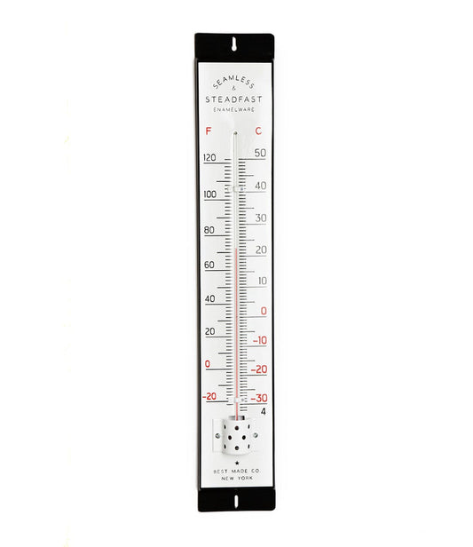 A vertical thermometer with Fahrenheit and Celsius scales, labeled Seamless Steadfast Enamelware, made by Best Made Co. in New York, showing a black top and bottom border.