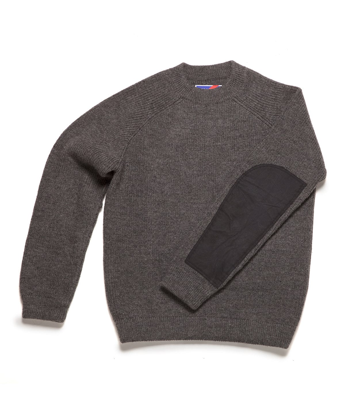 A gray knit sweater with black elbow patches on the left sleeve, laid flat on a white background.