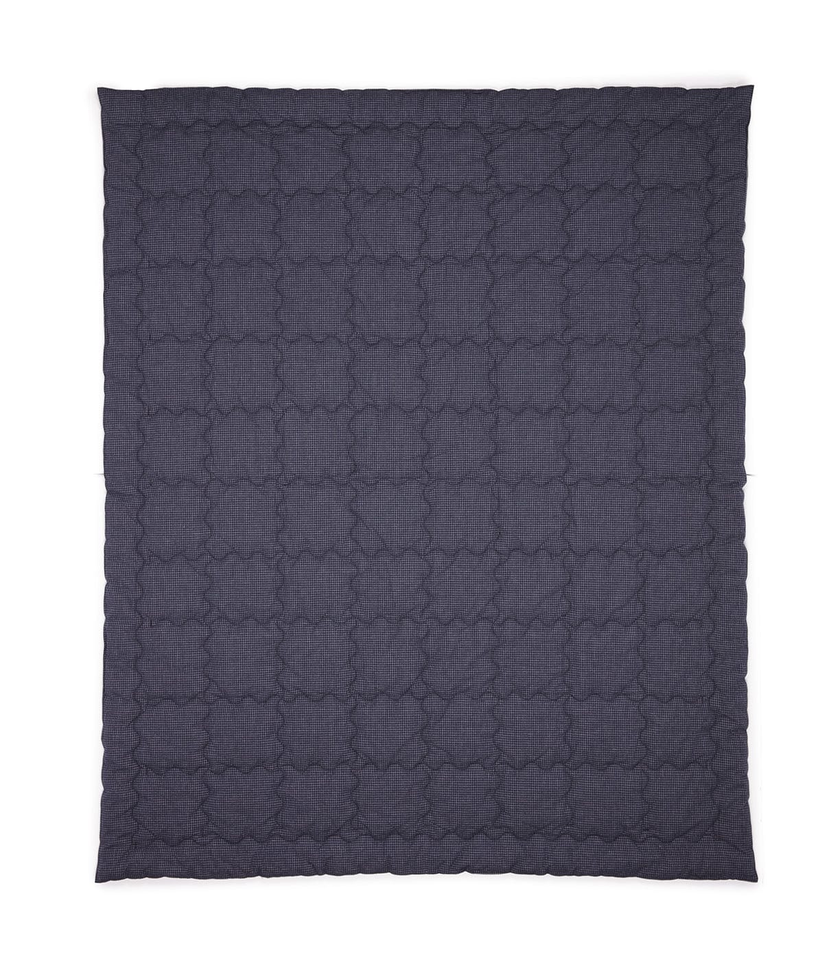 A dark gray quilt with a cloud-like stitched pattern is spread flat, covering the entire frame of the image.