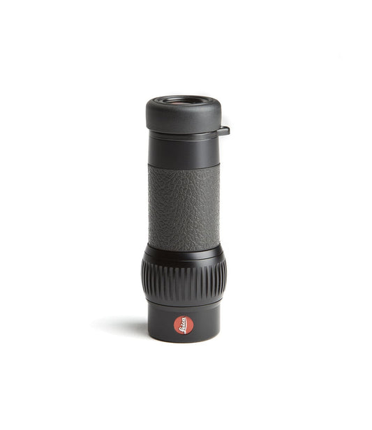 A black monocular with a textured grip and a branded red logo near the bottom, standing upright against a white background.