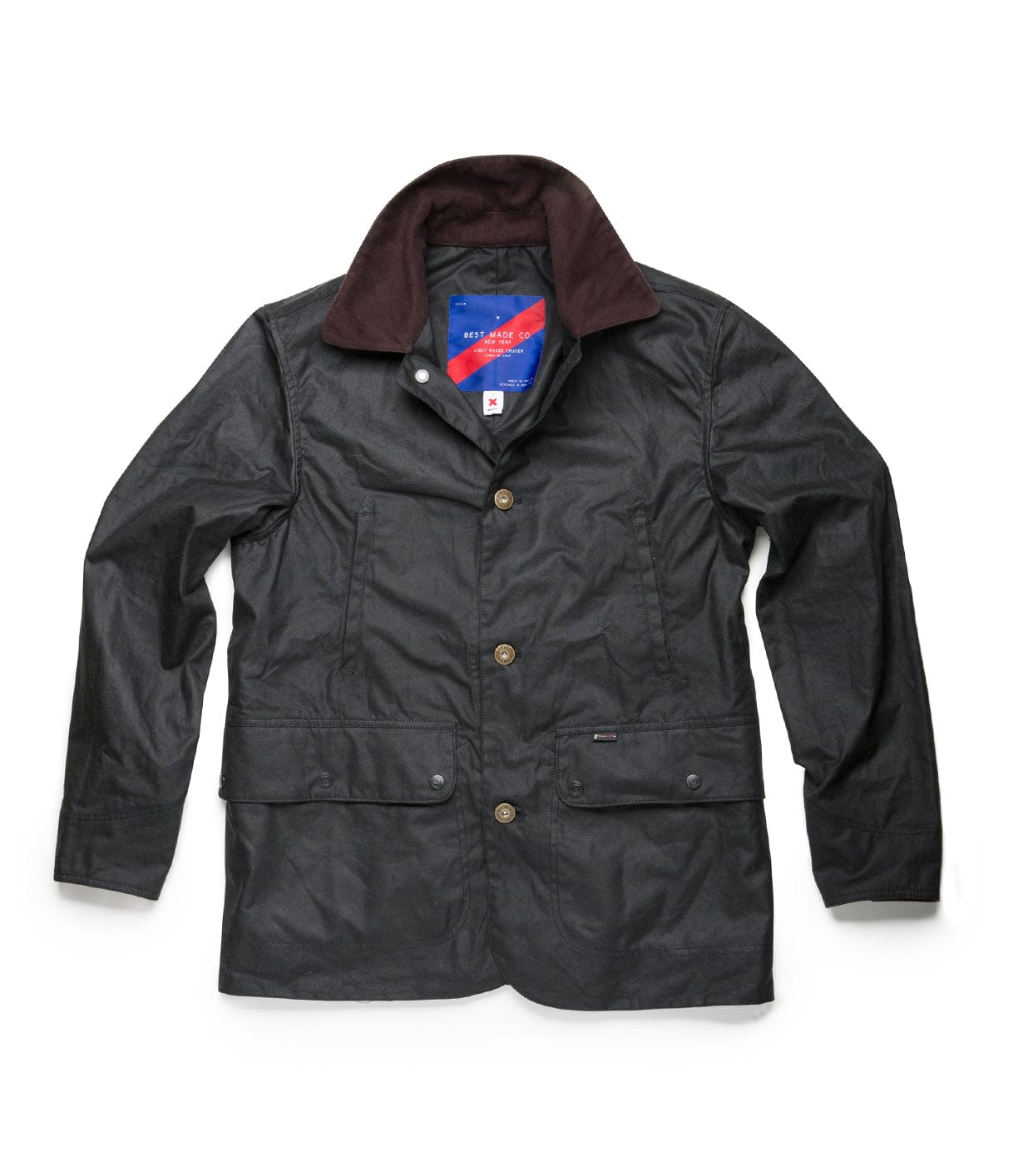 A black button-up waxed jacket with a dark brown collar, featuring two front pockets and a blue and red label inside the collar area.