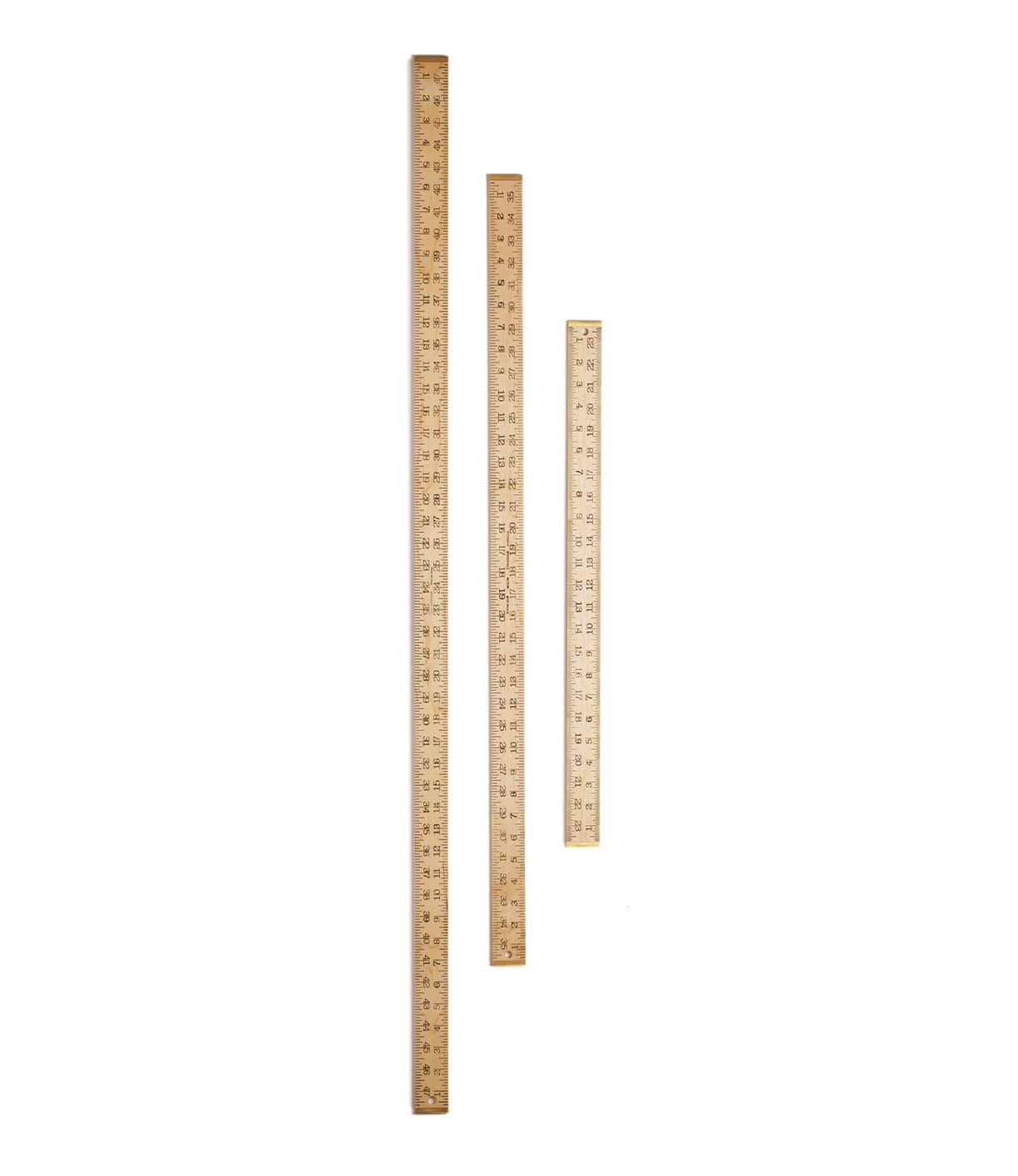 Three wooden rulers of different lengths, aligned vertically against a white background.