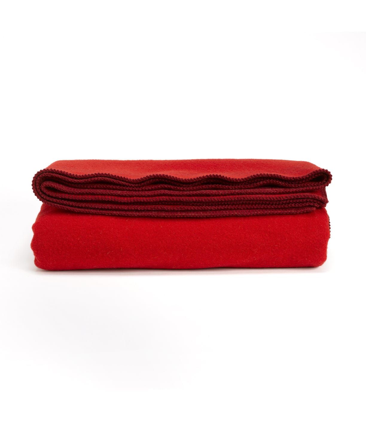 A neatly folded red blanket with a scalloped edge is displayed on a plain white background.