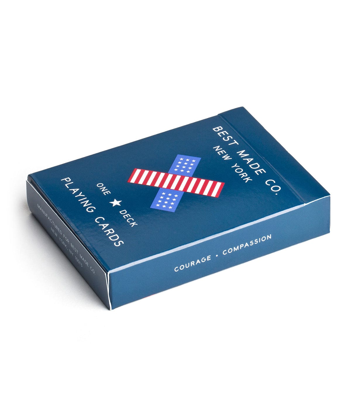 A blue box of playing cards from Best Made Co. with the words Courage and Compassion printed on it. The box features a red, white, and blue bandage design.