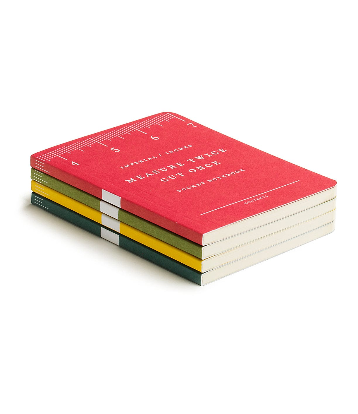 A stack of four notebooks, each with a different colored cover: red, yellow, green, and beige. The top notebook reads, Measure Twice, Cut Once with a ruler design on the edge.