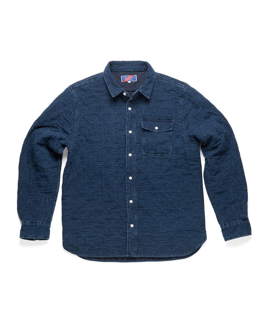 A long-sleeved, dark blue denim shirt with a quilted pattern, button-down front, single chest pocket with a button, and a collar.