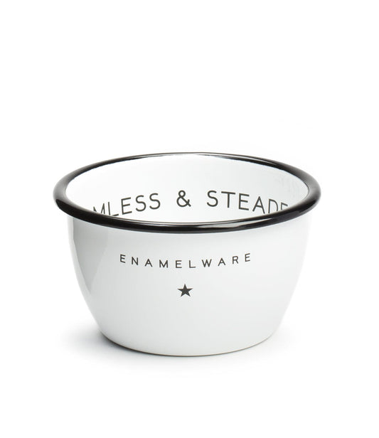 White enamel bowl with a black rim, featuring the text SEAMLESS & STEADFAST and ENAMELWARE along with a small star logo.