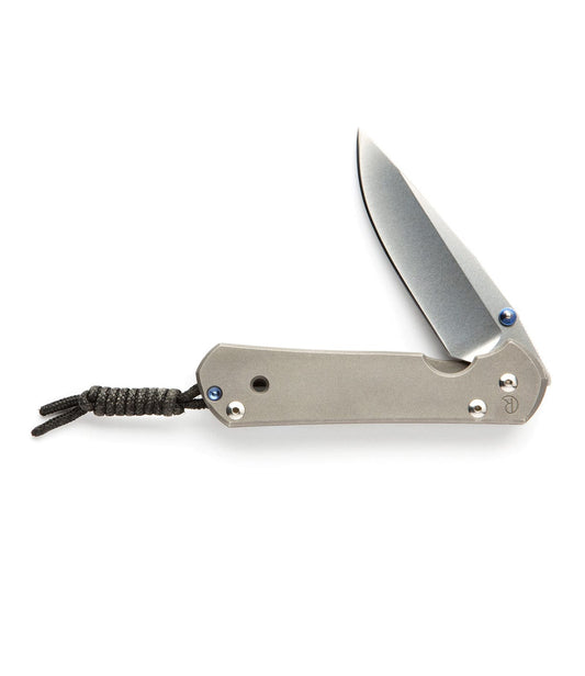 A partially opened folding knife with a gray handle, visible blade, and a knotted cord attached to the handle's end.