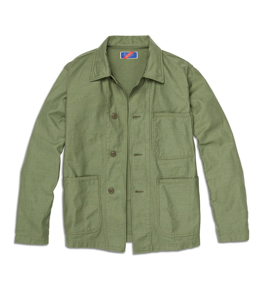 A green button-up utility jacket with four front pockets and a blue and red label inside the collar.