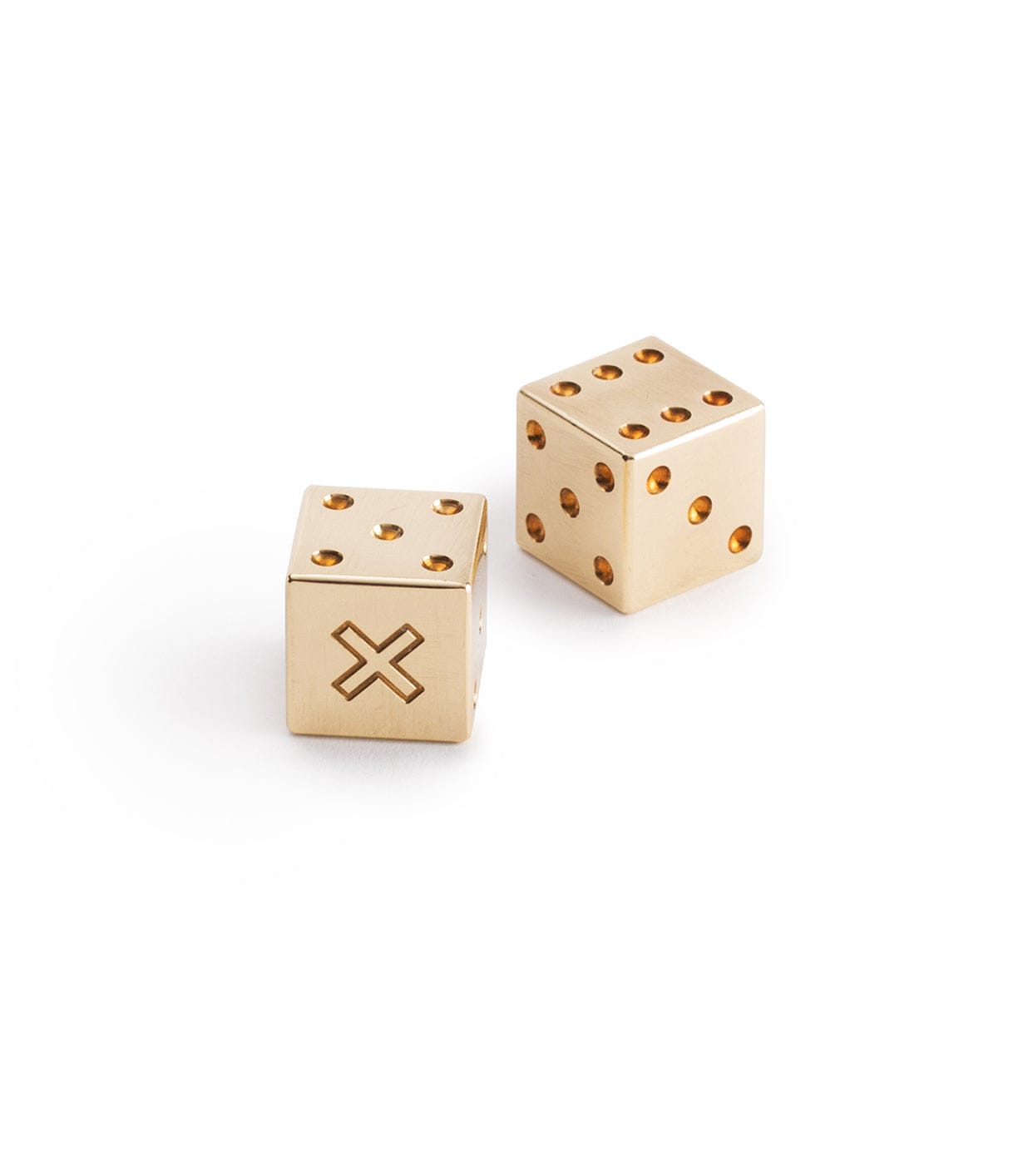 Two brass dice facing different directions; one has an X on one side, and both have dots on other sides.